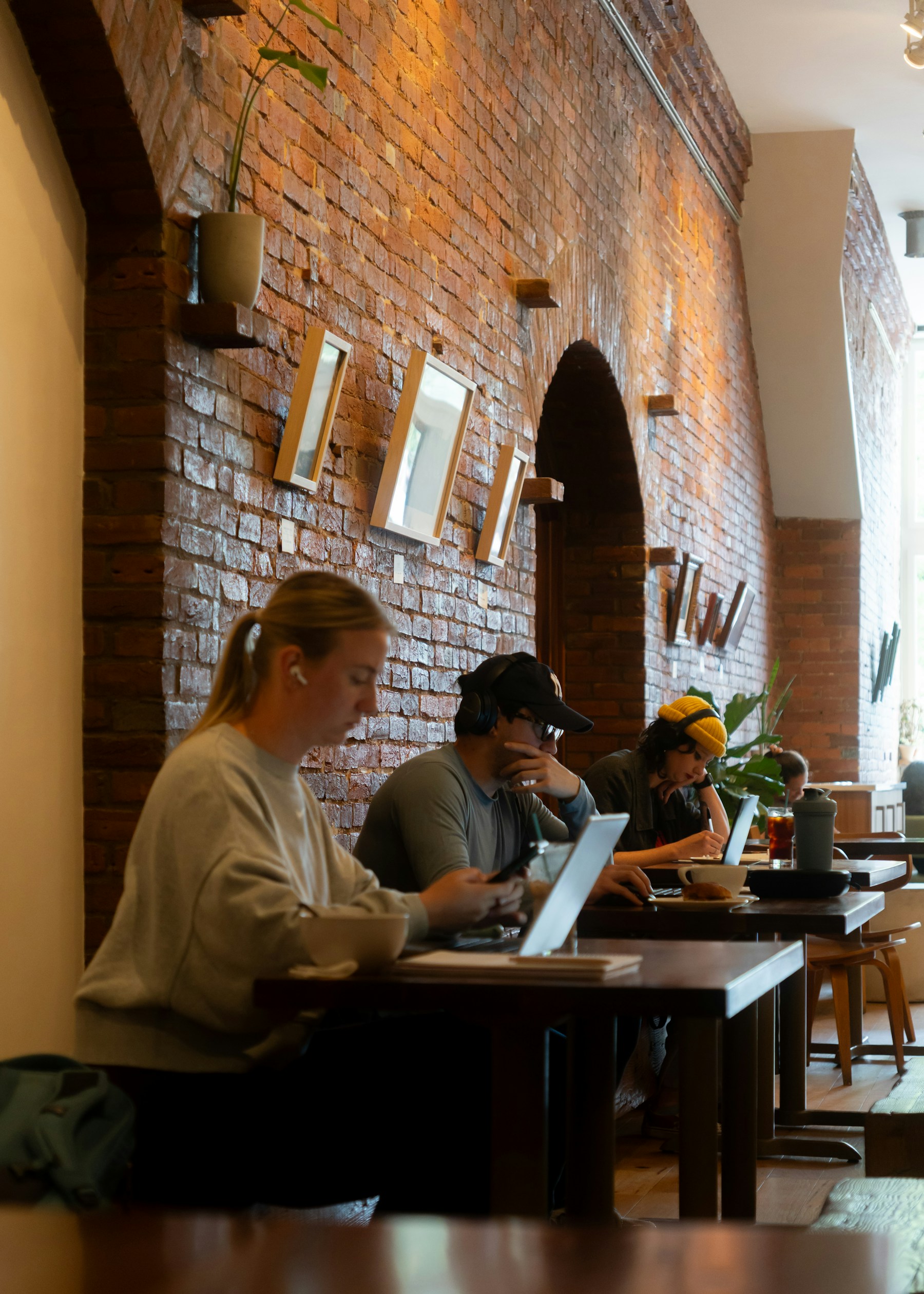 People working on laptops in a café